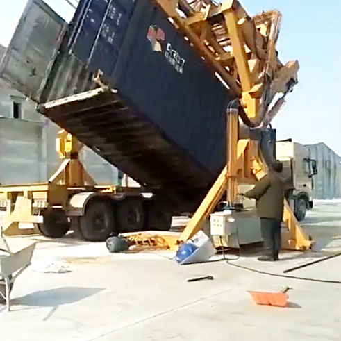 Workers are operating the container tilter